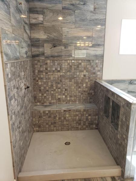The tile on the walls are Happy Floors, Citrus 12x24 color: Ocean in the polished finish, the 2x2s to match underneath and the pencil in between and on the edges are Shaw, Pearl 1/2x12 color: Blue Grigio. Finishing with the marble pan in color: Platinum White.